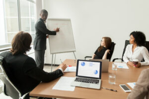 a man giving lecture to 3 women
